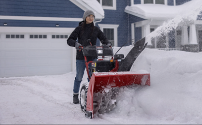woman using snow blower